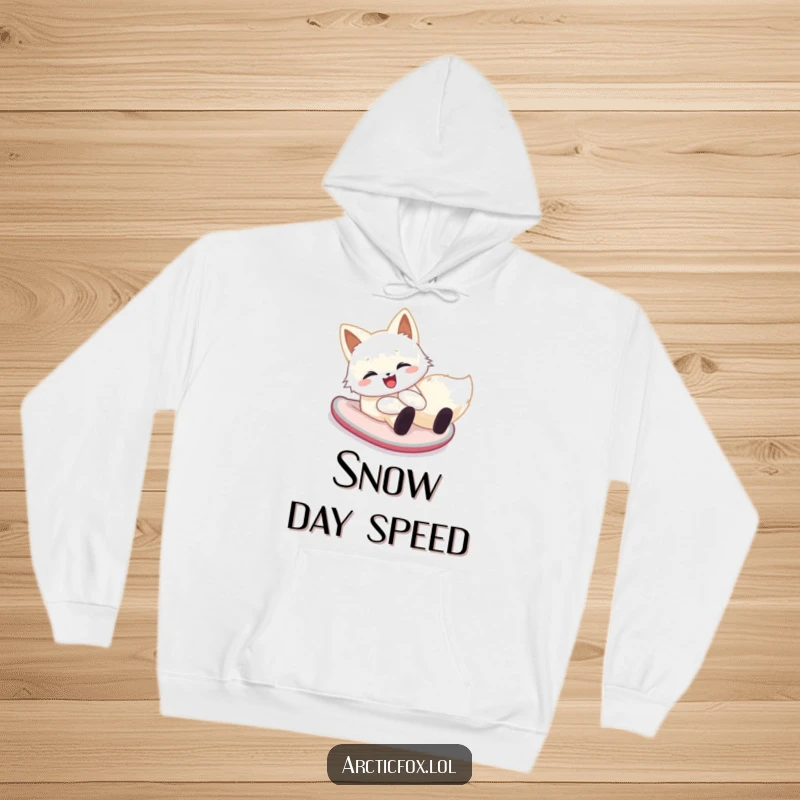 Funny arctic fox hoodie showing a happy creature cheerfully sliding down a snowy hill on its belly, perfect for cozy winter days.