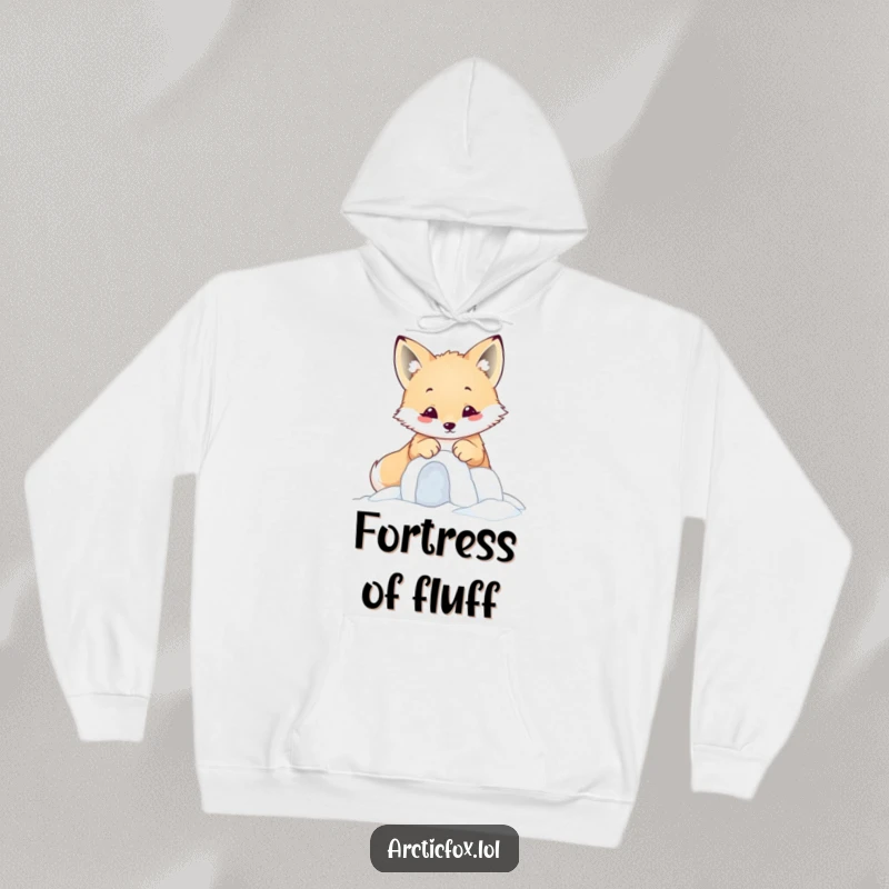 Funny kawaii arctic fox focused on building a miniature snow fort with its paws, on a comfy hoodie.