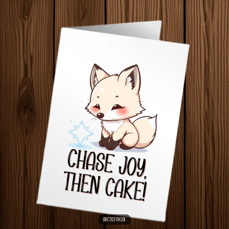 Funny Free Printable Birthday Card: Playful Arctic Fox joyfully chasing a single shimmering snowflake with its pink nose.