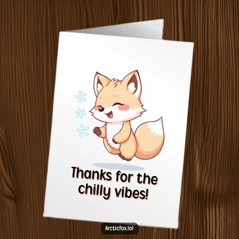 Funny Free Printable Thank You Card of a cute kawaii arctic fox playfully chasing a swirling snowflake, conveying warm thanks.