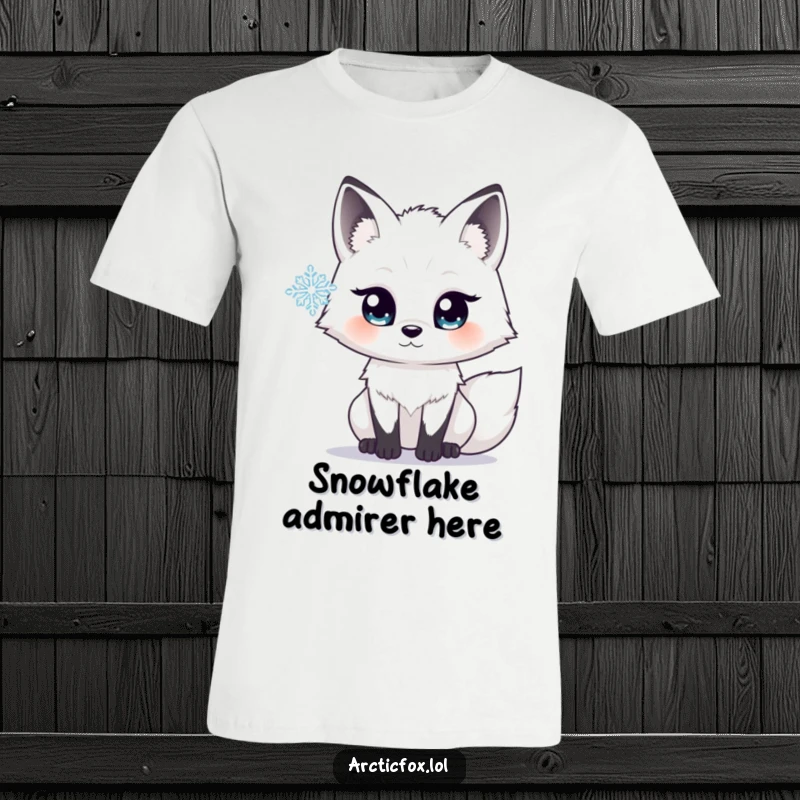 Funny t-shirt with an arctic fox sporting wide, sparkling eyes, intently watching a snowflake fall, capturing a moment of pure wonder.