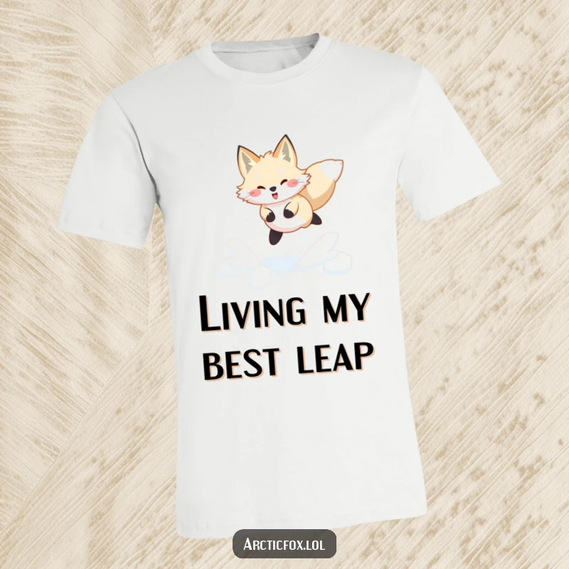 Funny Arctic fox t-shirt depicting a joyful leap through fresh, powdery snow, full of playful winter humor.