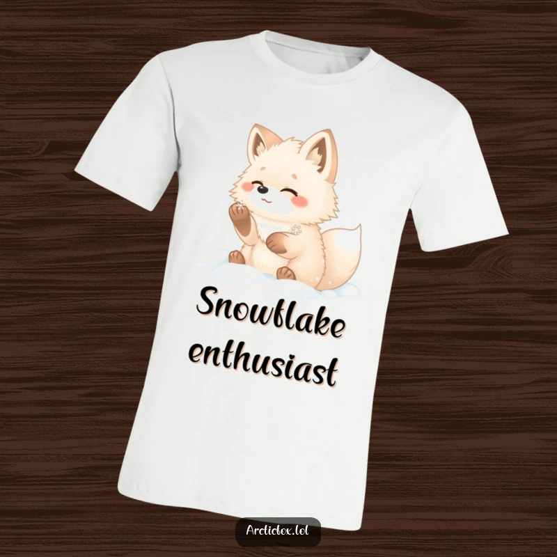 Funny arctic fox t-shirt featuring a fluffy fox joyfully catching a snowflake in the snow.