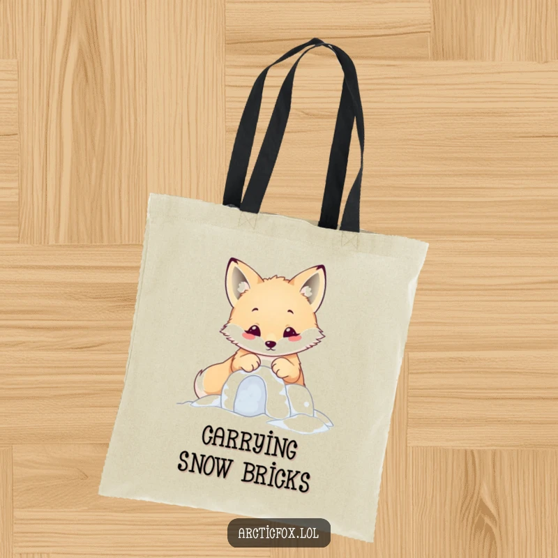 Funny kawaii arctic fox building a tiny snow fort with its paws, presented on a cute tote bag.